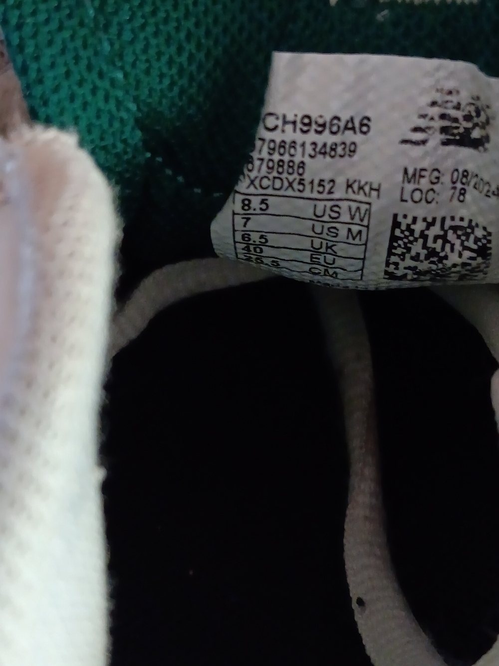 White and Green Athletic Shoe Interior - Size Tag Visible